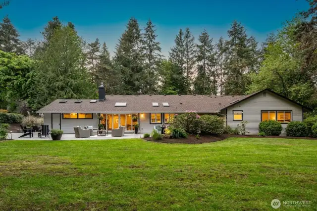 Stunning home on a sunny lot with impeccable landscaping, a large concrete patio area that wraps around the home!