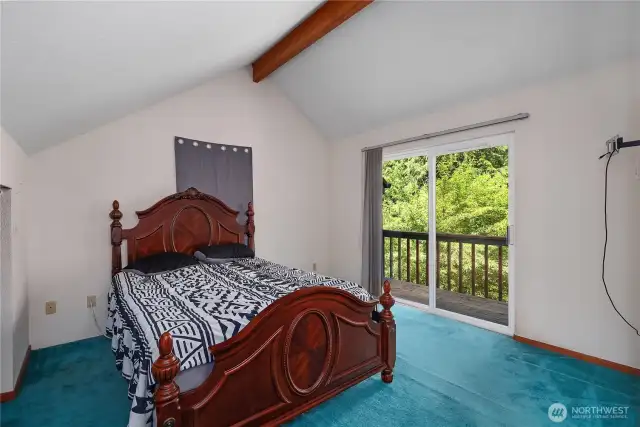 Primary bedroom with your private balcony looking onto the landscape.