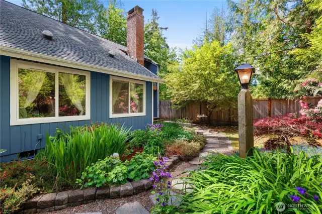 Front yard with beautiful trail throughout. Fully fenced with a gate.