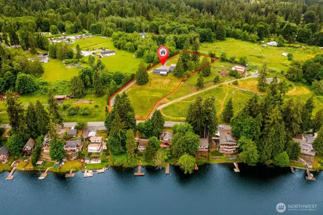 Set on almost two acres of peaceful land, this property combines the best of country privacy with lake access just across the street. The red outline shows your generous lot — ideal for gardening, recreation, or expansion potential.