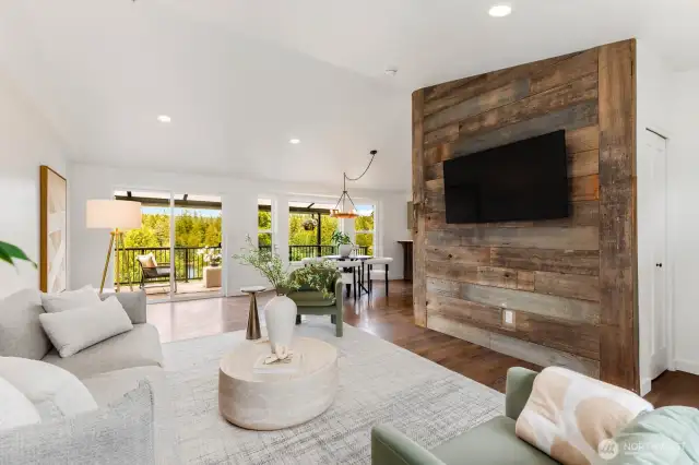 A reclaimed wood accent wall with mounted TV brings texture and warmth, grounding the modern design with rustic charm. Movie nights just got a serious upgrade.