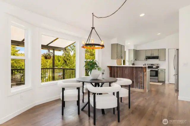 This sun-drenched dining nook is framed by nature and warmed by style. Sip your morning coffee while soaking in serene, tree-lined views from every angle.