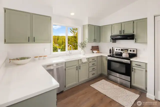 With sage green cabinetry, crisp white counters, and stainless steel appliances, this kitchen balances character and function. Bonus: that dreamy lake view while you do the dishes!