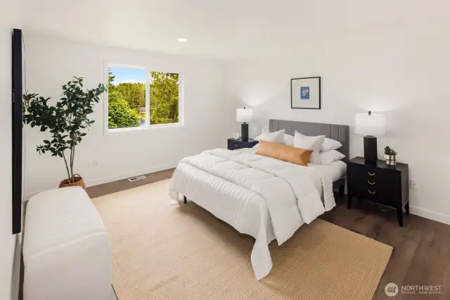 Wake up to nature just outside your window. With new paint, doors, trim, and modern flooring, this serene primary suite offers comfort, space, and an uninterrupted view of the trees and lake beyond.