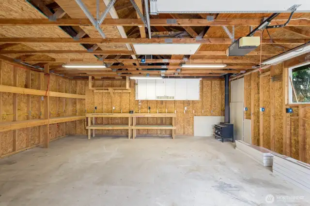The Ultimate Workshop Setup  Dreaming of a dedicated creative space or workspace? This detached garage features full power, built-in workbenches, cabinetry, and even a wood stove—ideal for year-round projects.