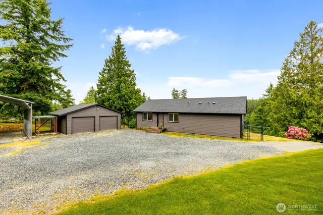 Room for It All – Vehicles, Toys & Tools  This oversized gravel driveway offers ease of access and ample parking, while the detached two-car garage and large carport provide perfect storage for your boat, RV, or weekend gear.