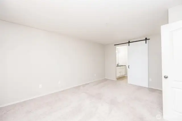 Main primary bedroom facing connecting bathroom