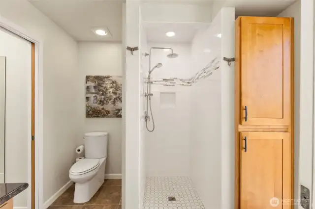 Another shot of primary bathroom with tons of storage and walk in shower.