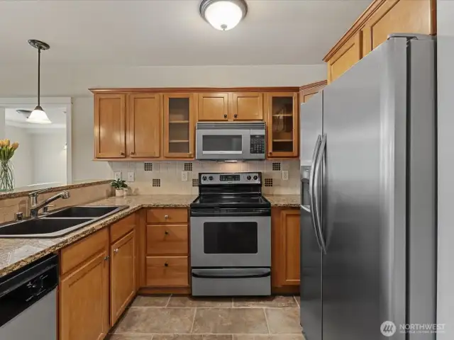 Social kitchen w/ granite counters, maple cabinets & tile flooring