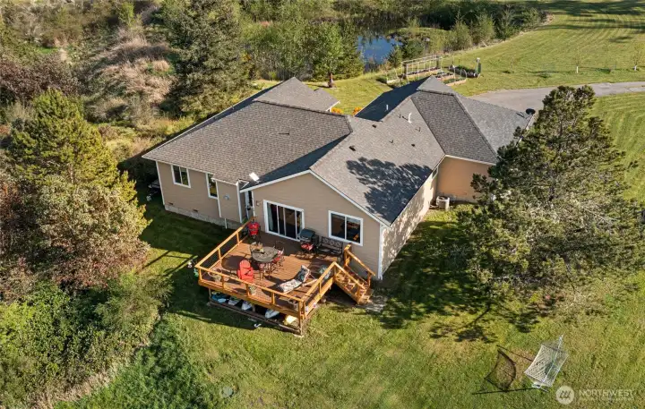 Spacious entertaining deck with sweeping views of the water and surrounding forest, perfect for dining, relaxing, or taking in sunsets.