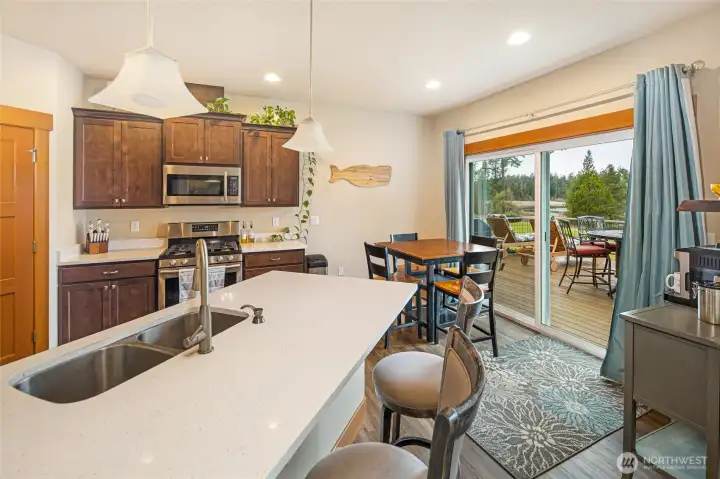 Open-concept kitchen and dining space with sliding doors to the deck, creating seamless indoor-outdoor living
