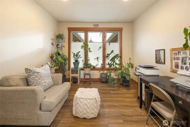 A versatile office or bonus room with large windows and natural light, ideal for working from home, hobbies, or a cozy reading nook.