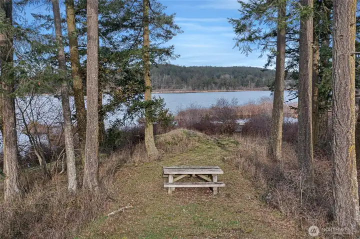 Idyllic setting on 2 acres, tucked alongside Sportsman's Lake and lush forest, offering both privacy and natural beauty.