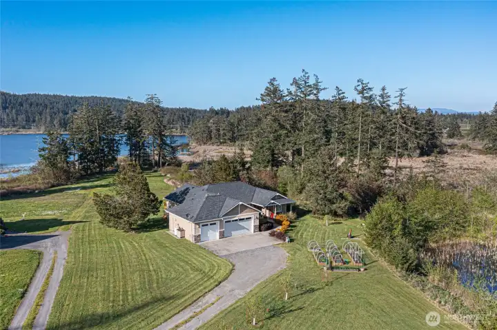 Charming single-level home with attached garage, set on a spacious lot featuring a picturesque private pond and expansive yard.