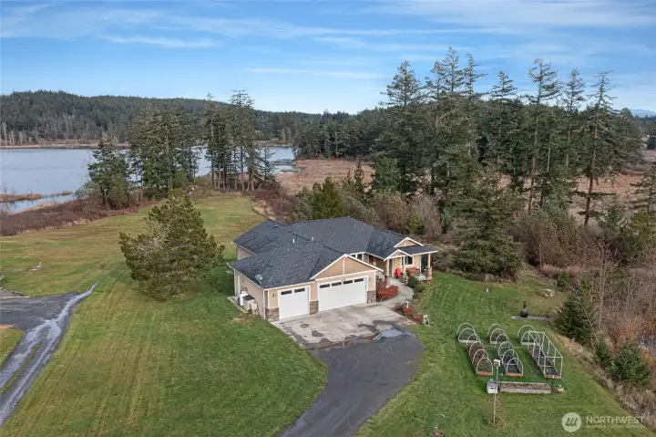 Charming single-level home with attached garage, set on a spacious lot featuring a picturesque private pond and expansive yard.