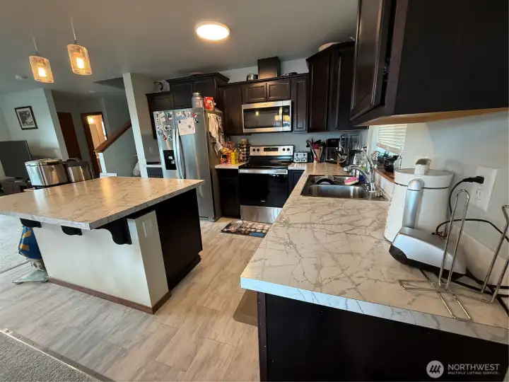 Well appointed kitchen with eating bar, seconds as great space for meal prep. Complete stainless steel appliances. All major appliances included.