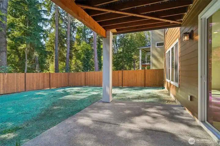 Covered patio on lower level.  Endless possibilities here to make this your very own, custom oasis.