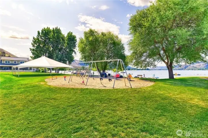 Large common lawn and playground by the beach