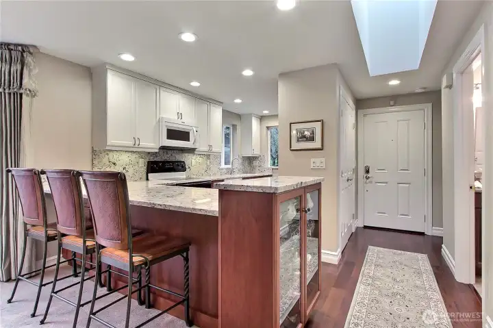 Breakfast bar and glass doored cabinet.
