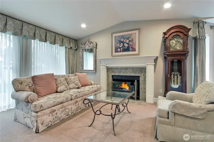 Lovely living room offers cozy fireplace and beautiful mantle. Sliding doors lead to the private back yard.