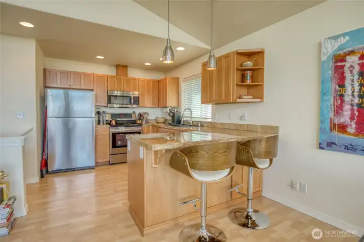 The kitchen has wonderful shaker cabinets and an eating bar.