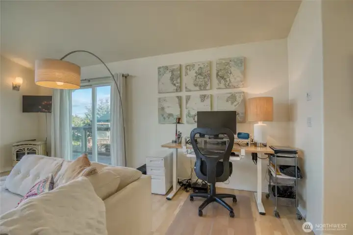 In th ecorner of the living space is a great corner for a desk space or a game table.