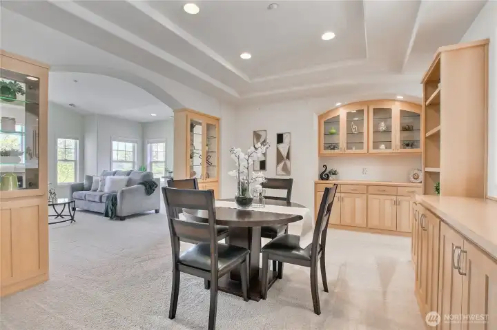 From dining room with coffered ceiling and can lights to the living room with vaulted ceilings.