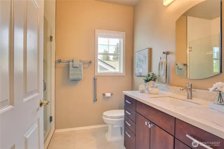 Second bedroom with tile surround and upgraded vanity and countertops.