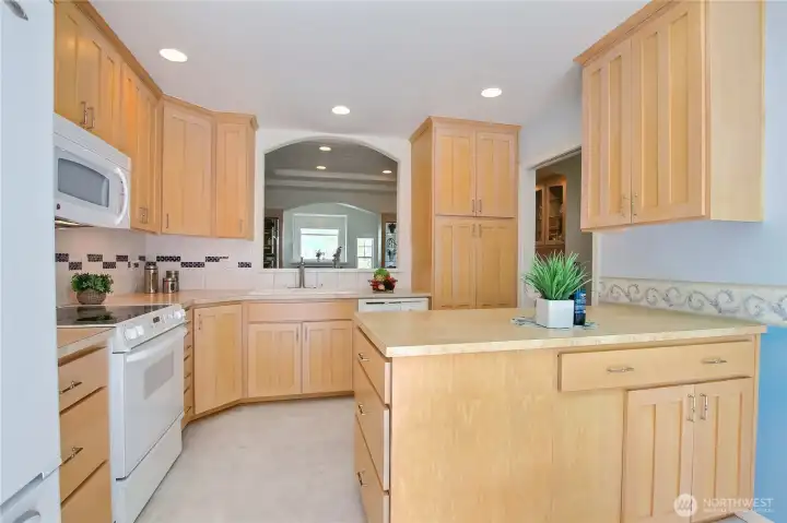 Spacious kitchen with peninsula, eating space, pass through and slider to patio.