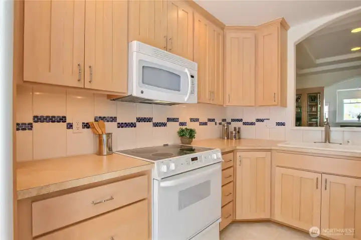 Kitchen features full height cabinets and loads of counter space.
