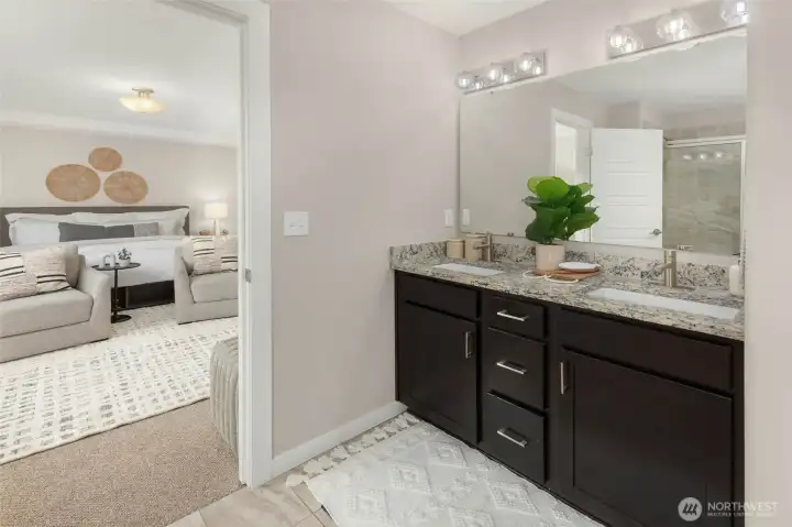 Primary bath with dual vanities, soaking tub and large walk-in closet.
