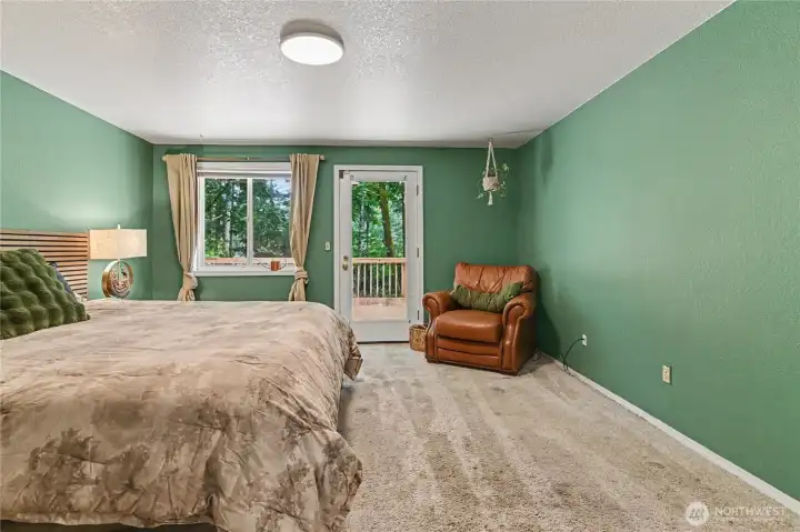 Primary bedroom offers a door to the back deck.