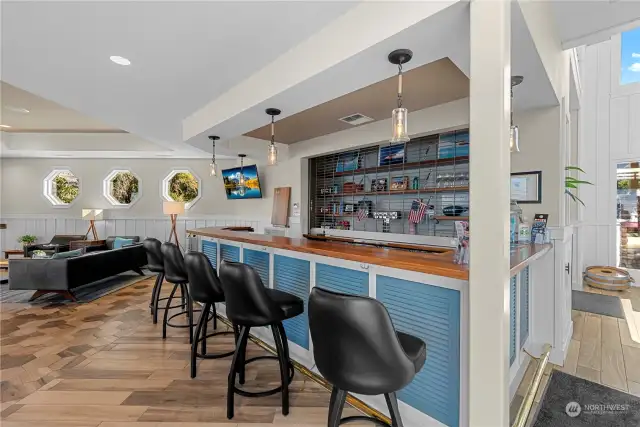 Pass by the wet bar as you enter the main floor lounge. Note the nautical-theme windows.