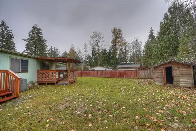 Private fenced lot with out buildings.