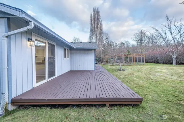 Rear deck with access from dining area and primary bedroom.