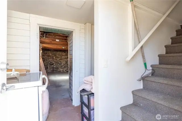 Stairs down from main level. About half basement is finished, about half unfinished for storage