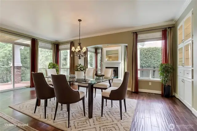 This is the dining/sitting area off of the kitchen. Second fireplace here, love the huge patio doors and all the windows! Plus built-ins on your right, and I think you will love the light fixtures throughout this custom home. ***Virtually Staged***