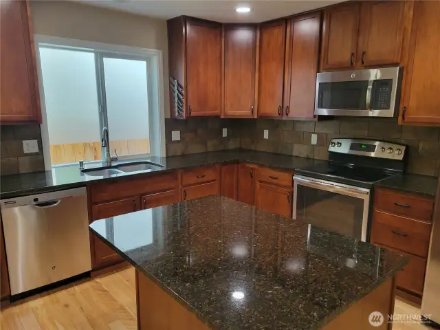 Kitchen with island and stainless appliances