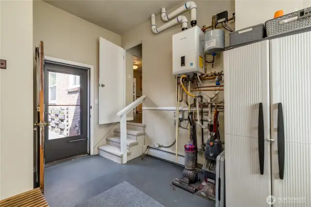 From utility room - stairs up to kitchen, door opens to patio