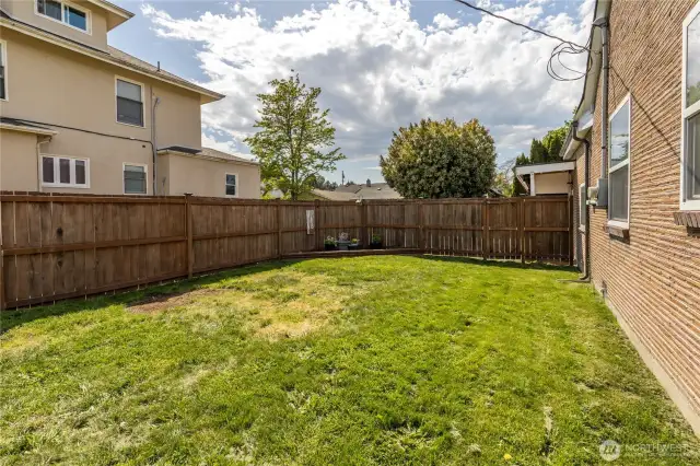 Fully-fenced yard with garden beds