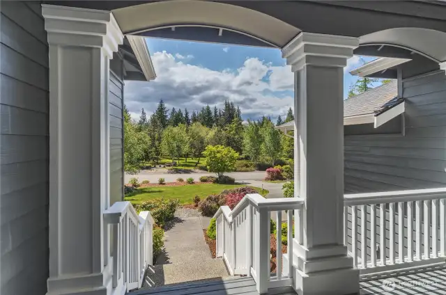 The covered front porch deck looks out directly at the community park in Olympic Terrace 1.