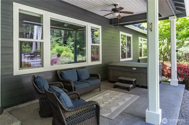 You can entertain and enjoy the outdoors all year long under this covered porch. Note the hot tub in the background! There is also a propane hook-up for your barbecues, plus a ceiling fan and light.