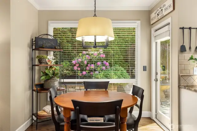 Enjoy your morning coffee in this perfect eating space overlooking the private and beautifully landscaped backyard.