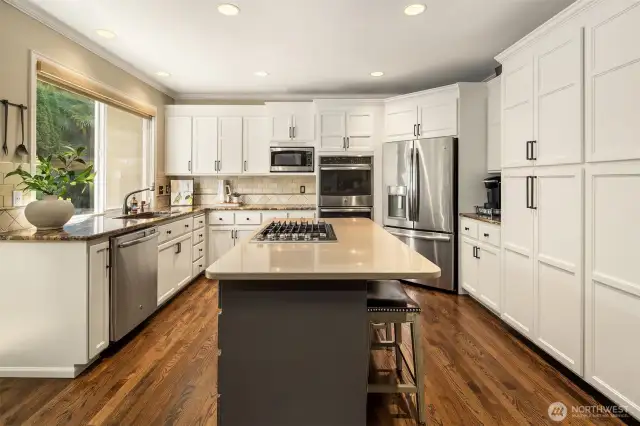Kitchen was extensively remodeled in 2017. Custom built cabinets, gas cooktop, extended granite island with counter space for stools. Cabinets have had Genie pull-out shelving installed in 2023.