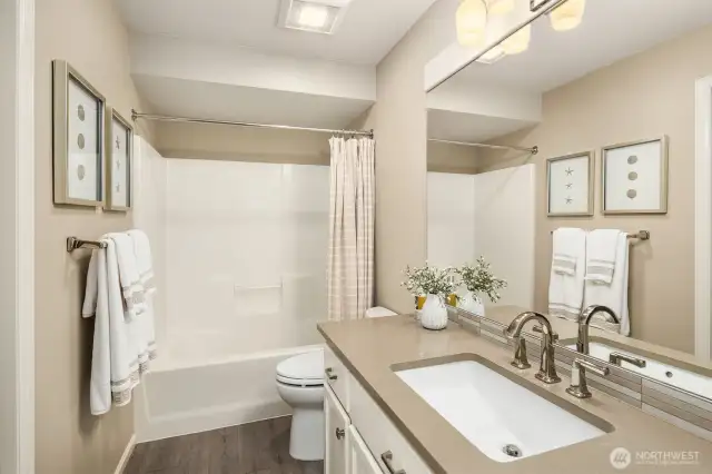Upstairs guest bathroom has soothing colors and is very spacious.