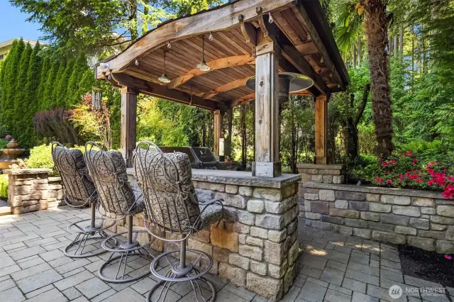 Invite all of your loved ones over! This roofed and lighted BBQ area has room for stools and is plumbed for gas. Eldorado stone throughout the backyard.