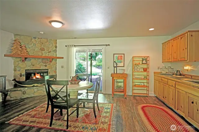 Bonus space downstairs with kitchenette, patio access and cozy fireplace.