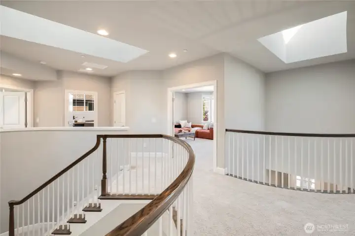 Spacious upper-level landing with large skylights for abundant light.