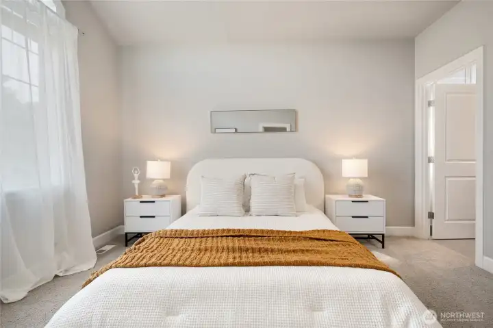 Sun filled bedroom suite on upper level with private bathroom and walk in closet.
