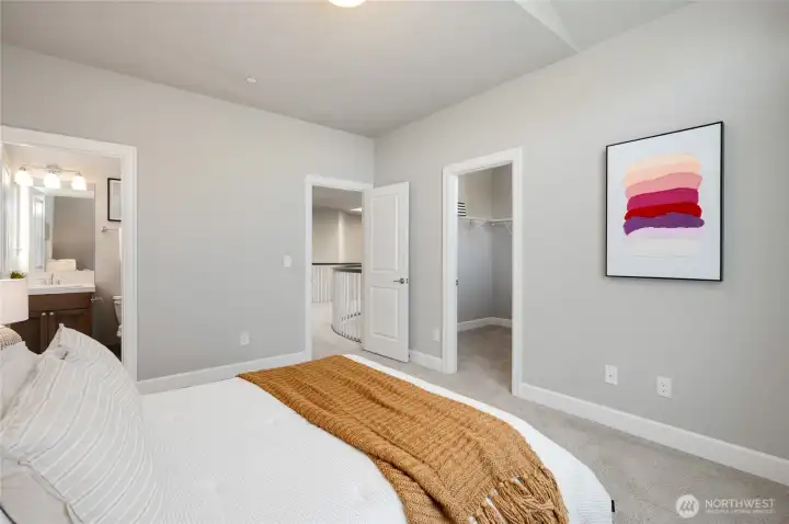 The bedroom suite has a private bathroom, walk-in closet, and vaulted ceilings.